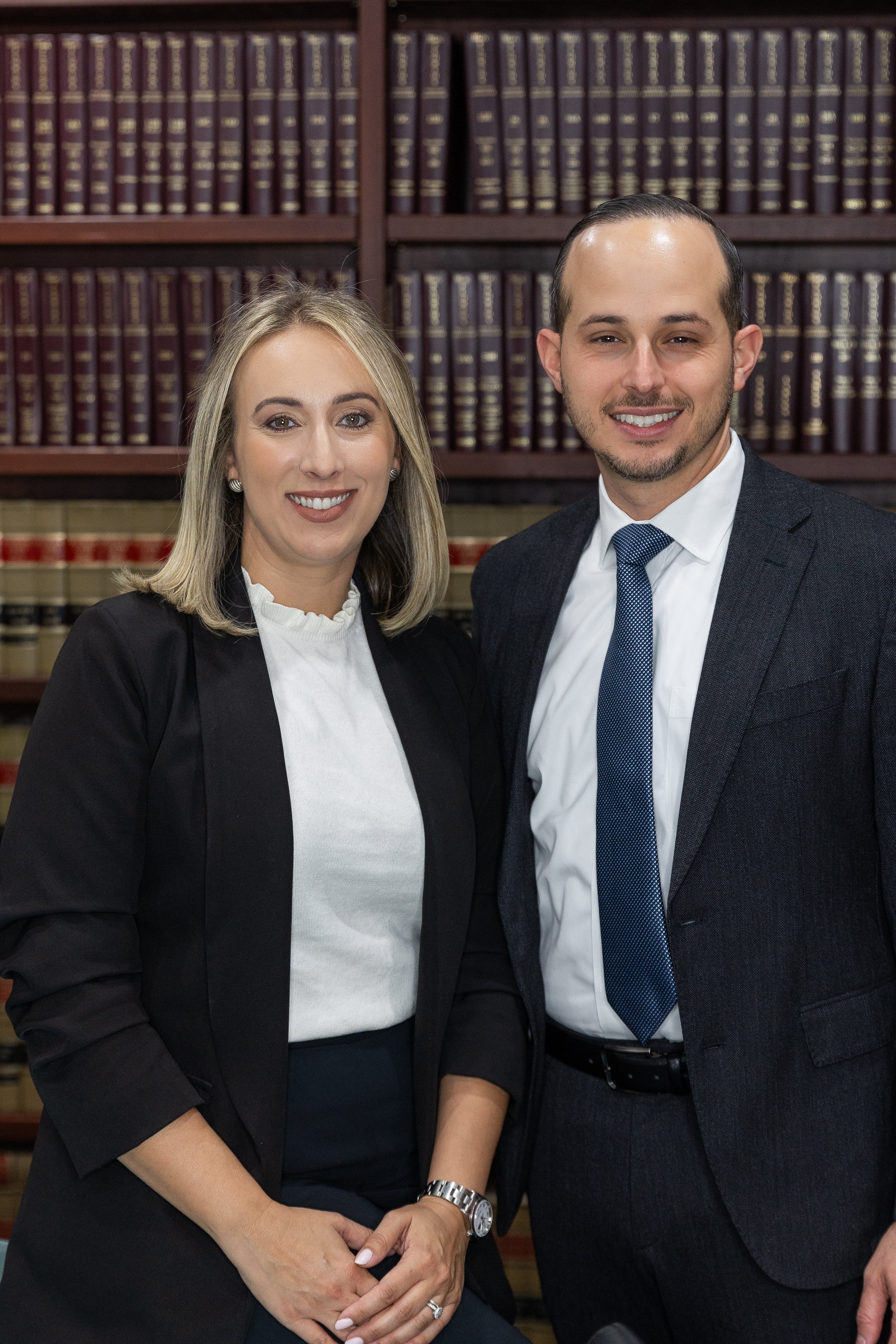 Carlos and Monica Aguila in their law library at Aguila Law, Miami
